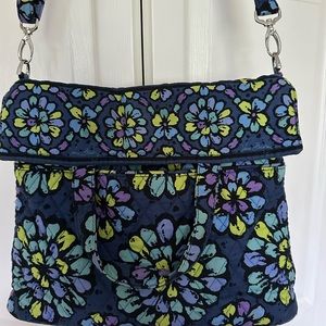 Vera Bradley 2 way bag with multiple storage options.